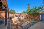 Enchanting outdoor space with luxurious hot tub, a gas grill, and a gorgeous xeriscape garden and flagstone pathway